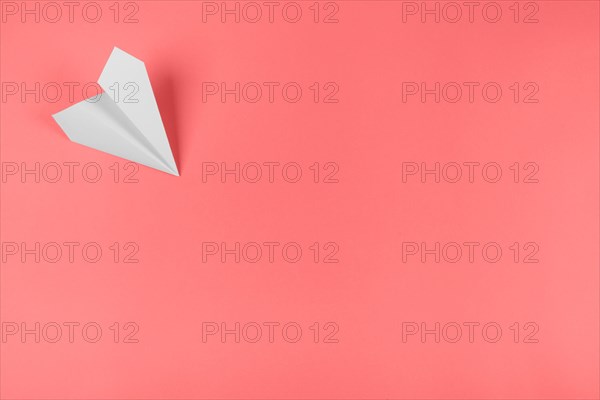 White paper airplane corner coral background. Resolution and high quality beautiful photo