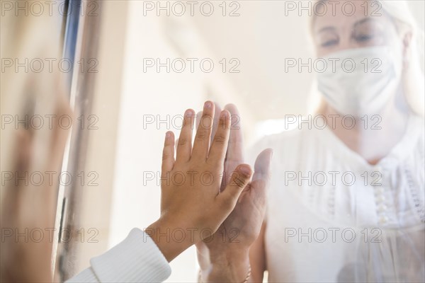 Woman with medical mask quarantine window with child. Resolution and high quality beautiful photo