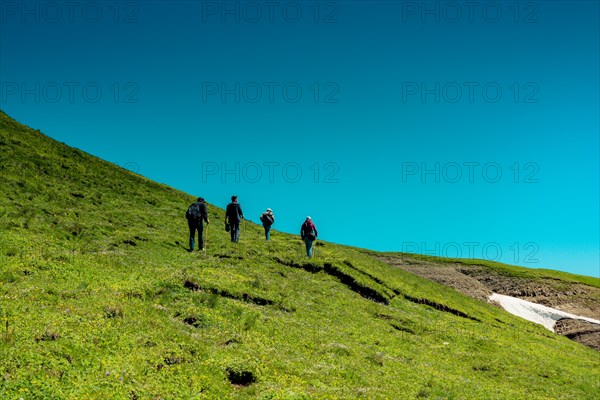 Hikers with backpacks and trekking poles walking in Turkish highland