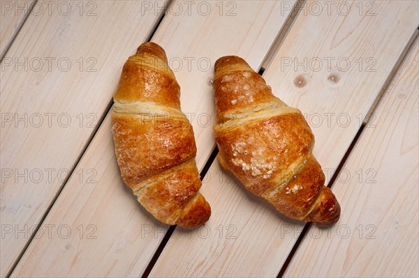 A pair of fresh croissant on the table