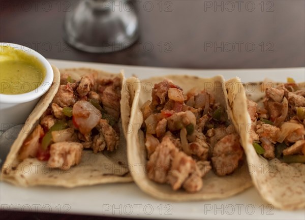 Mexican tacos al pastor served with hot sauce