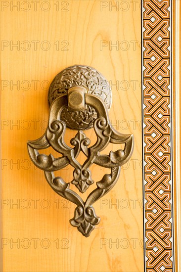 Old Handmade ottoman door knob on wood