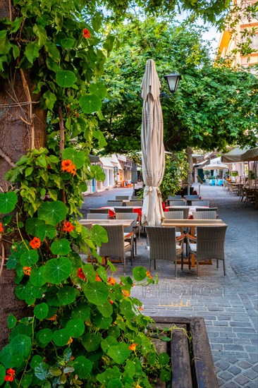 Street cafe in scenic picturesque streets of Chania venetian town with coloful old houses. Chania greek village in the morning. Chanica