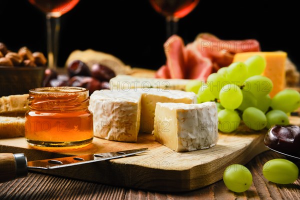 Close up view of brie cheese on plate with snack for wine