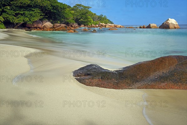 Beach and rocks of Anse Lazio in the evening