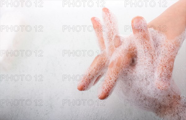 Hand washing and soap foam on a foamy background