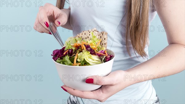 Woman holding big bowl with vegetable salad. Resolution and high quality beautiful photo