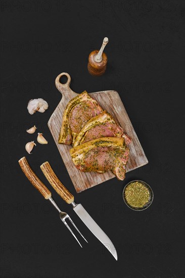 Top view of marinated pork steak with spice ready for barbecue