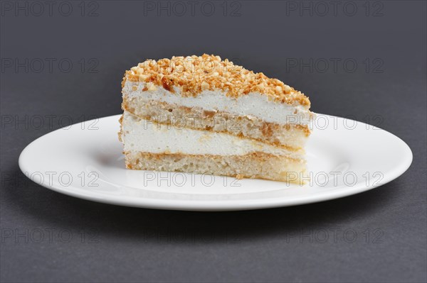 Piece of biscuit cake with souffle on a plate