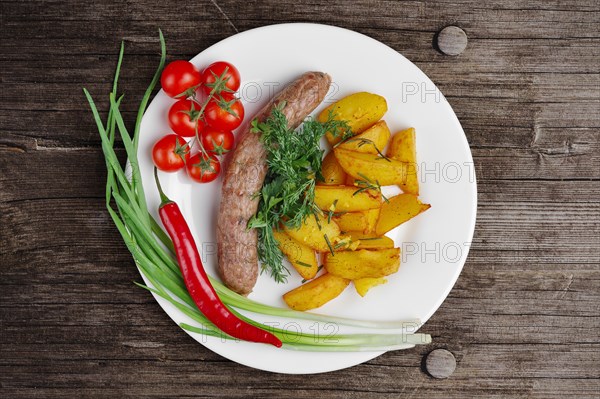 Top view of homemade sausage with fried potato