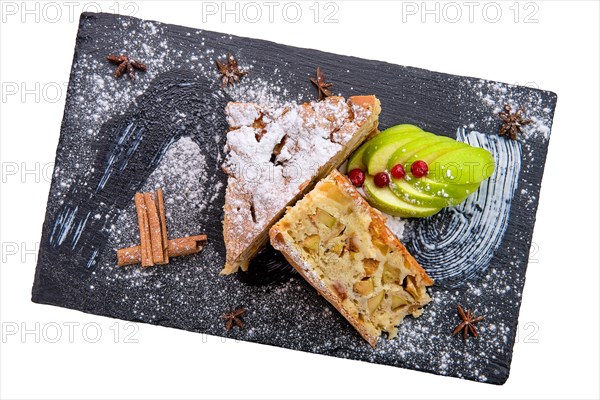 Apple pie on slate plate isolated on white