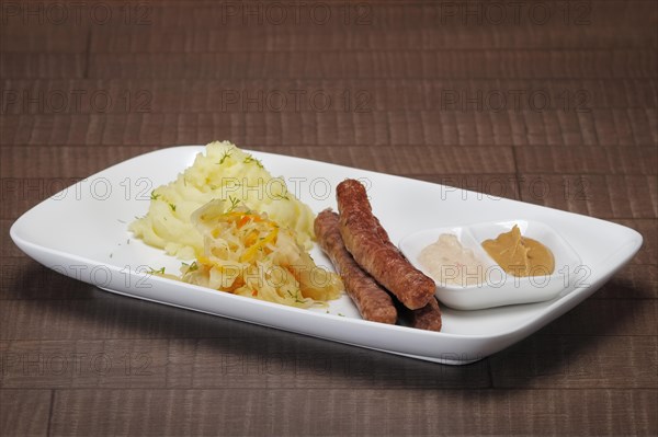 Homemade sausage with mashed potato and sauerkraut