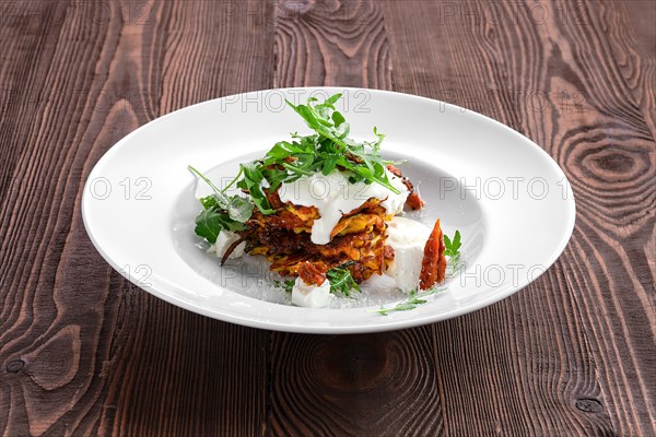 Pumpkin fritters with soft cheese and sun-dried tomato