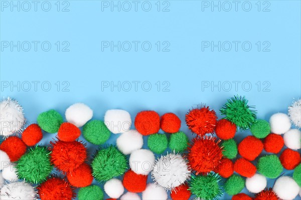 Fluffy round pompons in traditional Christmas colors red