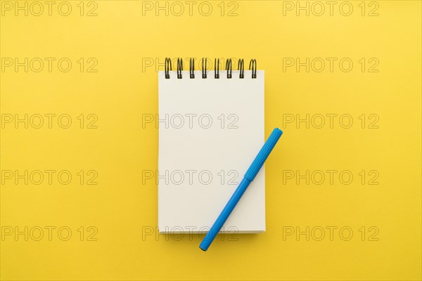 Notepad with pen yellow background. Resolution and high quality beautiful photo