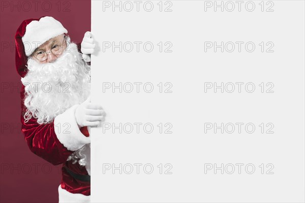 Santa claus looking out white wall