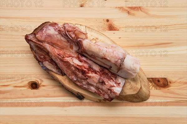 Frozen fresh octopus or squids raw on wooden board