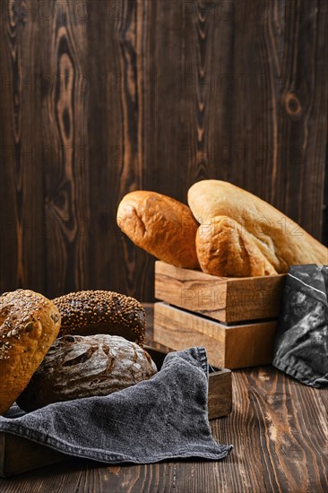 Assortment of cereal bread made of different seeds on wooden table