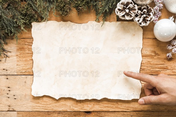 Hand near paper christmas decorations