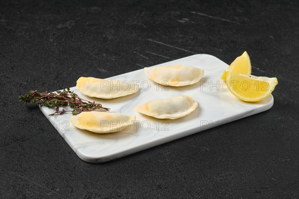 Semifinished frozen salmon dumplings on serving board