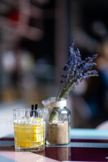 Whiskey sour cocktail on the table on blured bar background. Photo with shallow depth of field