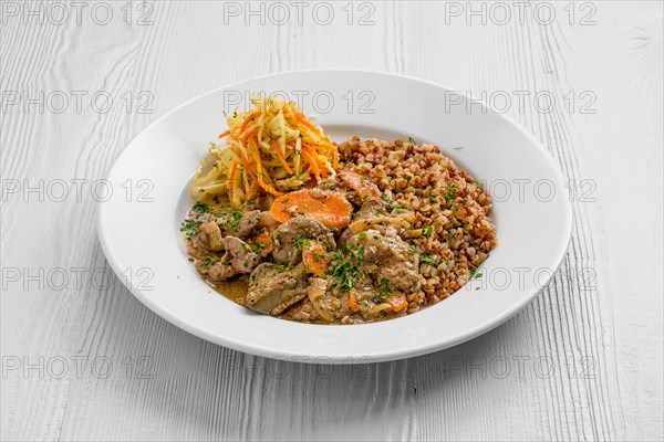 Plate with chicken liver with buckwheat and pickled cabbage salad