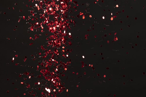 Red glitter on black background