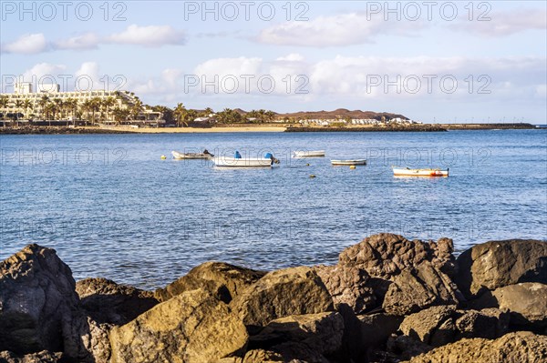 View of the resort town named Costa Teguise with boats on the foreground