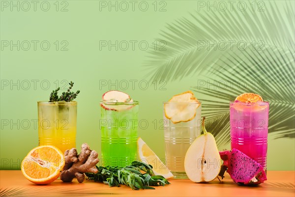 Variety of iced beverages or lemonade in tall facetted glasses
