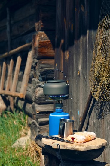 Boiling water in hiking kettle. Outdoor cooking equipment