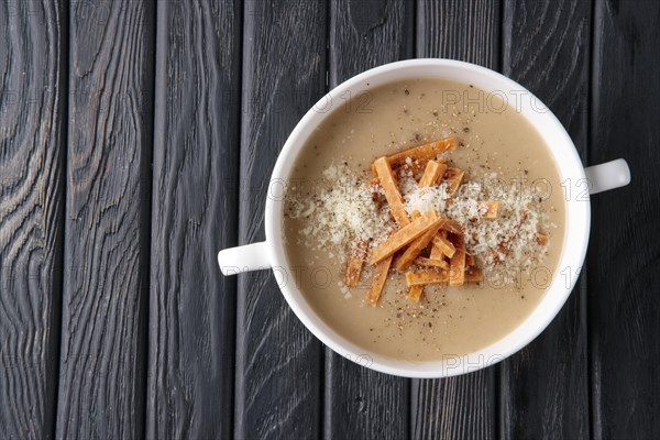 Top view of mushroom soup puree with chips