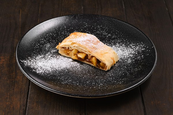 Piece of classic apple strudel on a plate