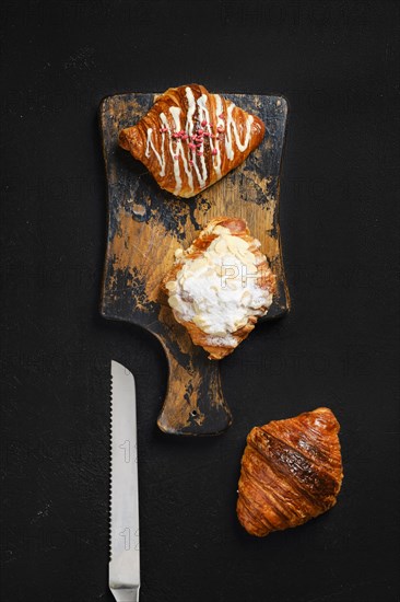 Top view of assortment of crispy croissants on serving board