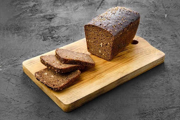 Top view of loaf of brown sourdough bread with sunflower seeds and sesame