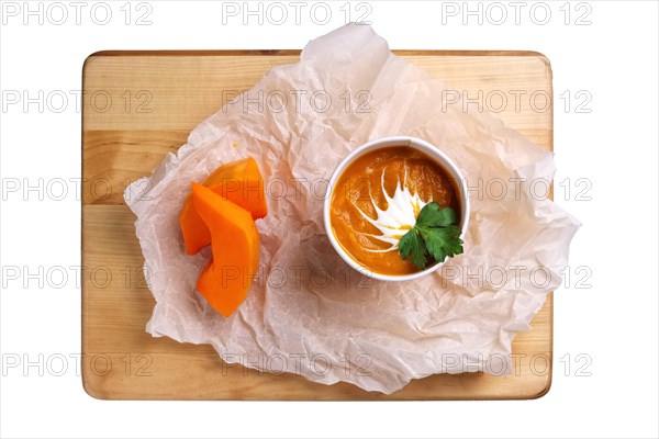 Top view of plate with batata cream soup with sour cream isolated on white