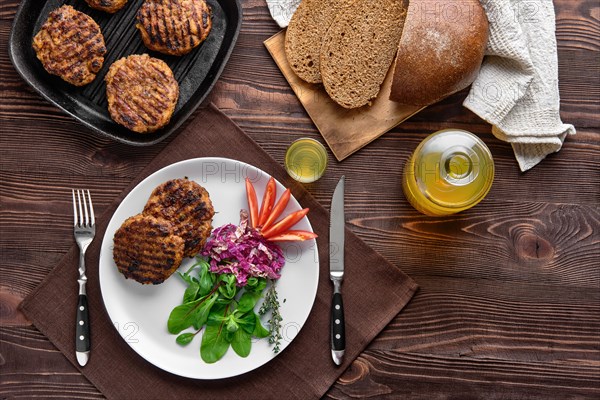 Top view of country dinner with cutlet and fresh salad