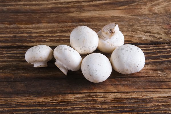 Fresh champignon on wooden background