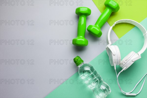 Flat lay frame with headphones dumbbells