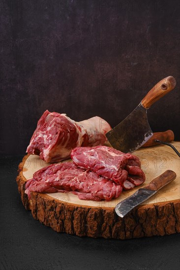 Chopped pieces of fresh lamb neck on cutting stump