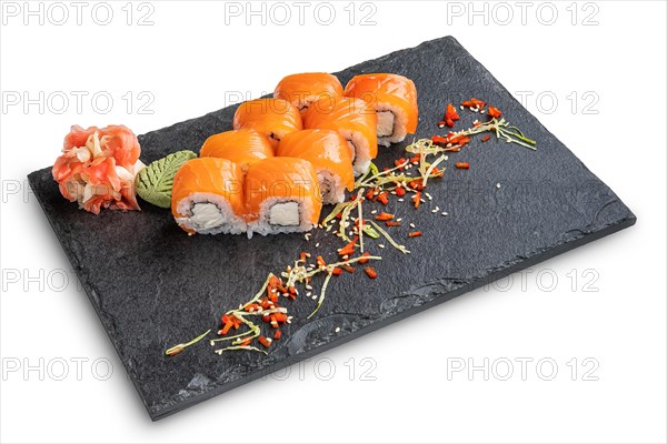 Set of rolls with wasabi and pickled ginger on stone serving board isolated on white