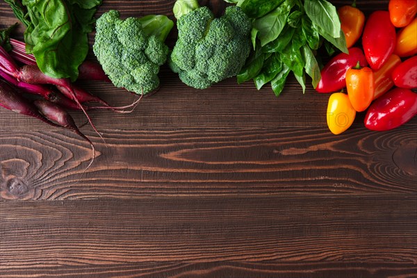 Fresh vegetables on dark wooden background