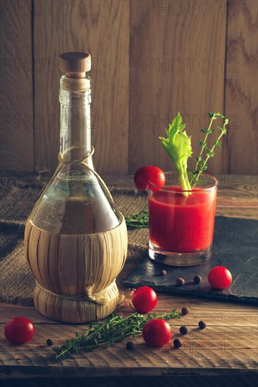 Rustic cocktail Bloody Mary with ingredient on wooden table