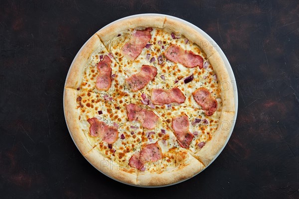 Top view of pizza carbonara with bacon and onion