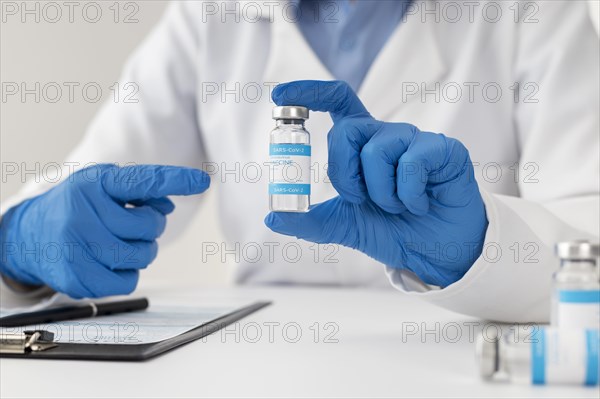 Close up doctor holding vaccine