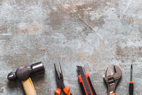 Different types worktools arranged row rusty wooden desk