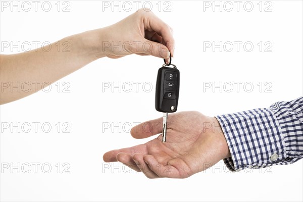 Hands exchanging car keys
