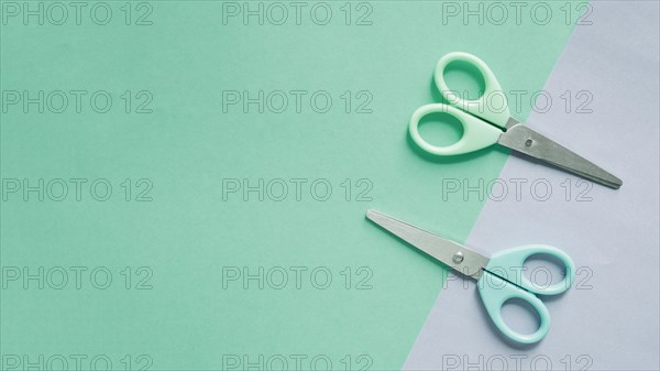 Overhead view two scissors dual colorful background 1
