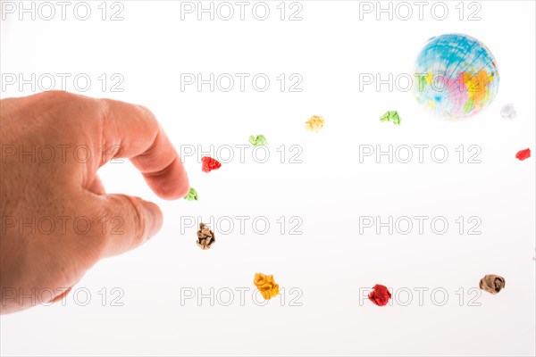 Globe orbit and hand touching crumpled papers on a white background