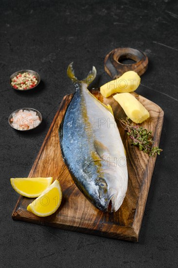 Raw fresh yellow tailed lacedra on wooden cutting board