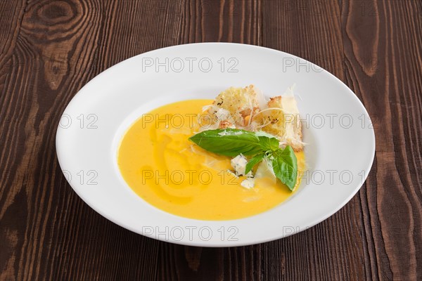 Cheese soup with blue cheese and crouton on dark wooden background